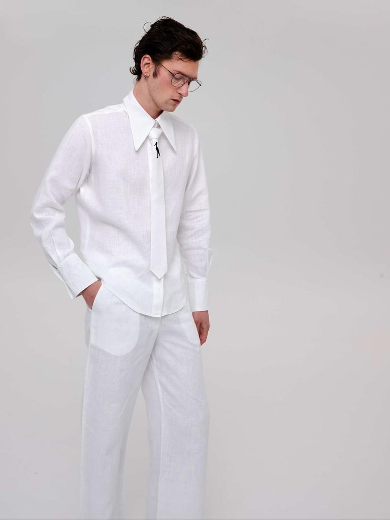 Лляні широкі штани середньої посадки з бічними кишенями в білому кольорі