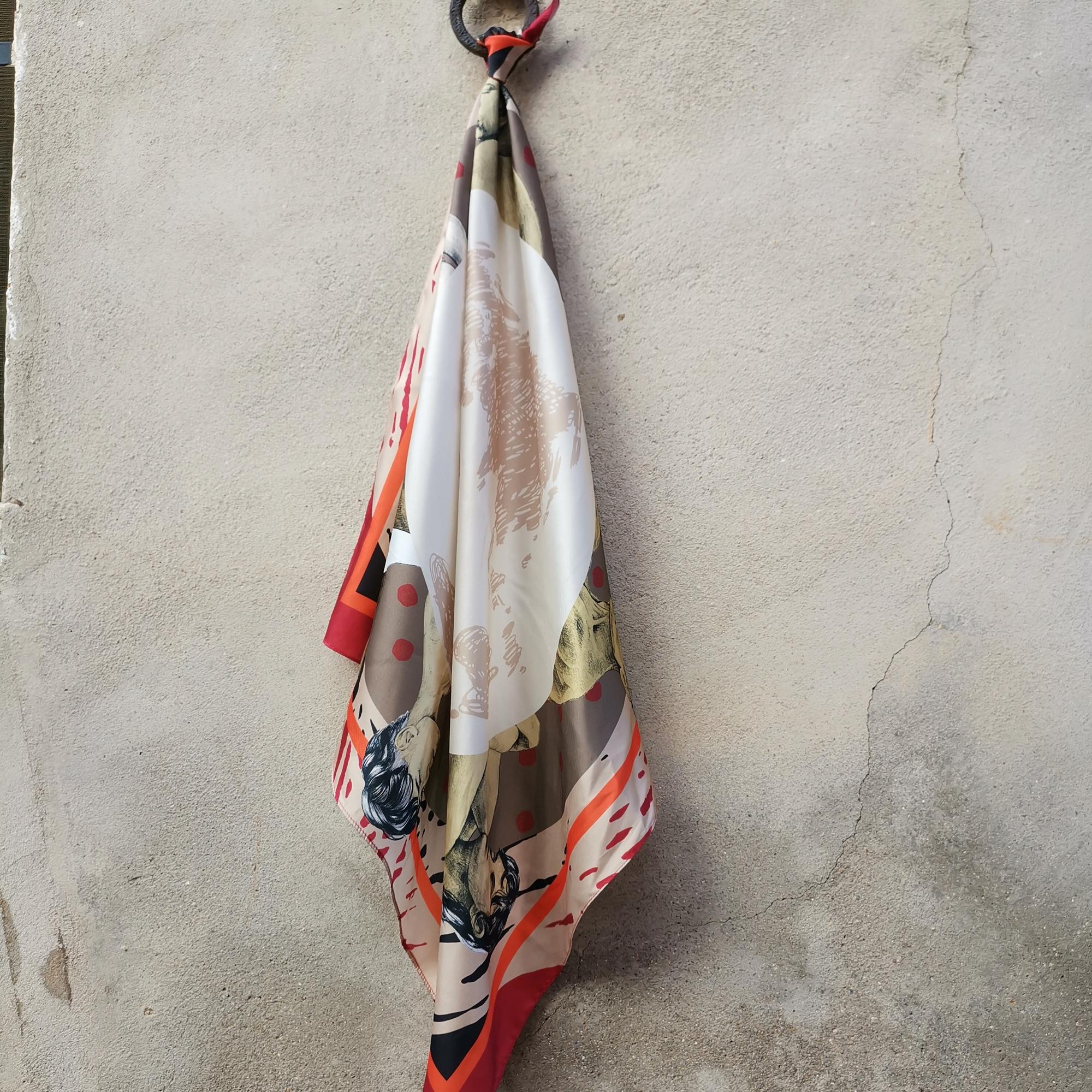 Red eco-silk scarf featuring illustrations of people in fetal position, textile artwork