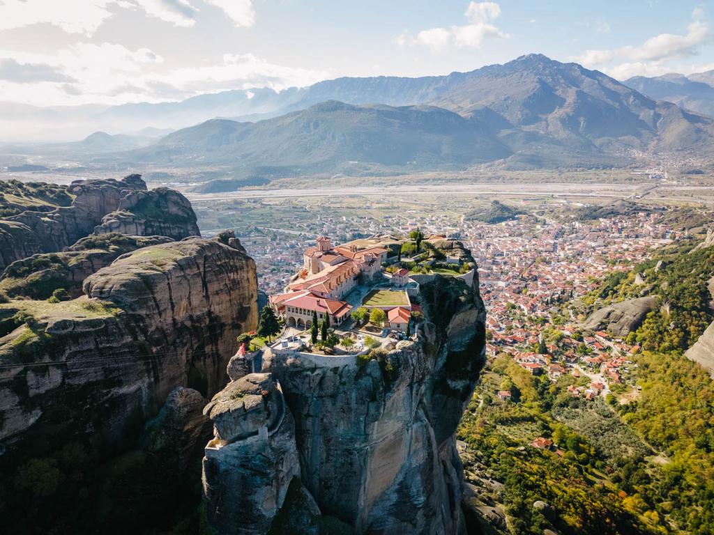 Aerial View of Meteora, Complex of Eastern Orthodox Monasteries, Greece, cyrcling around Holy Trinity Monastery